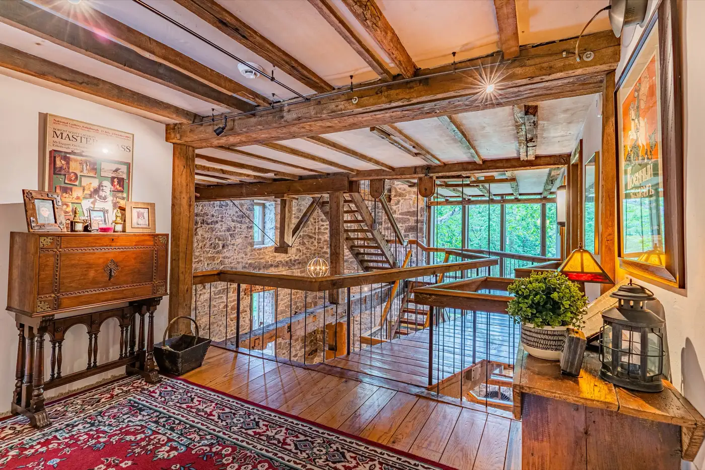 Upper hallway overlooking the multi-level timber-framed interior