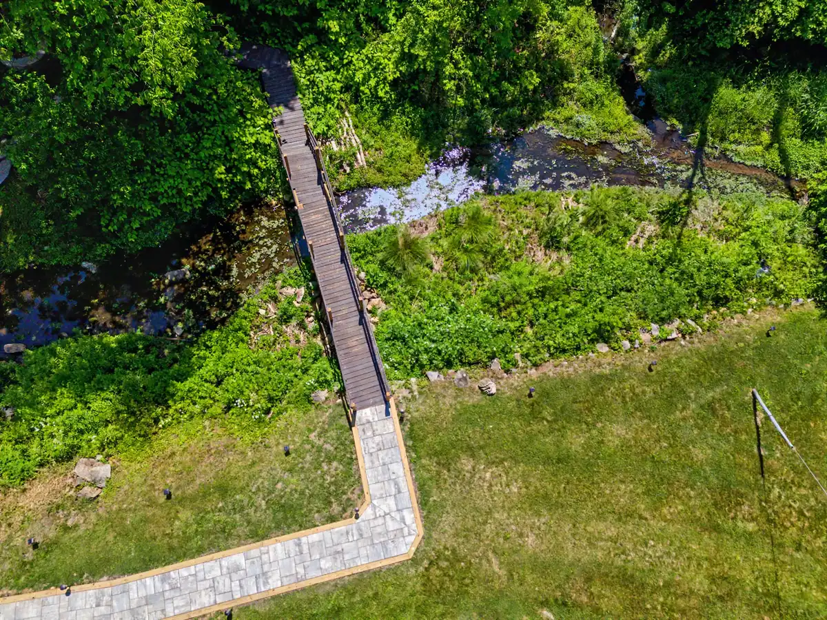 Aerial view looking straight down on the footbridge and the millstream below