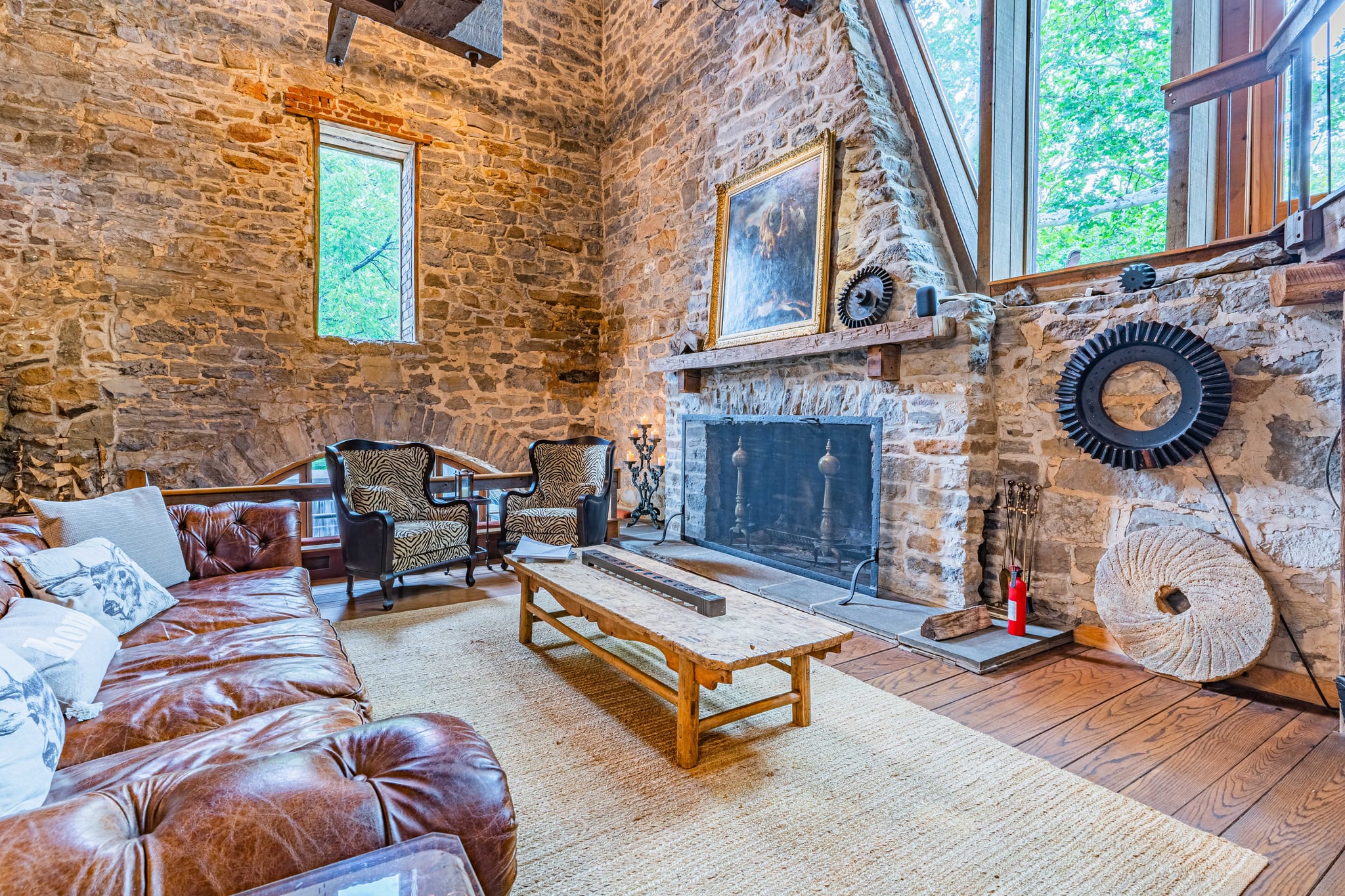 Kitchen island with rustic cabinetry and open plan to living area