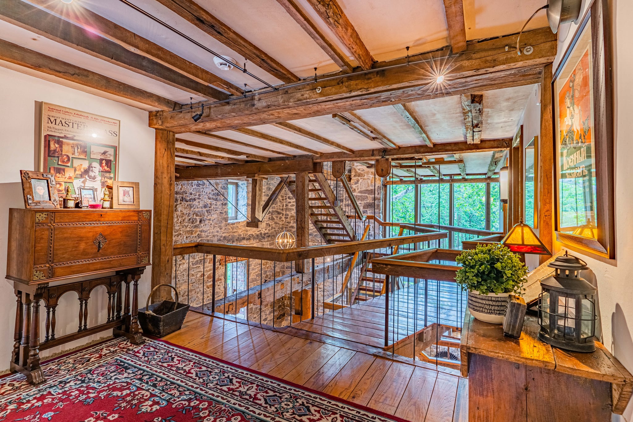 Upper hallway overlooking the multi-level timber-framed interior