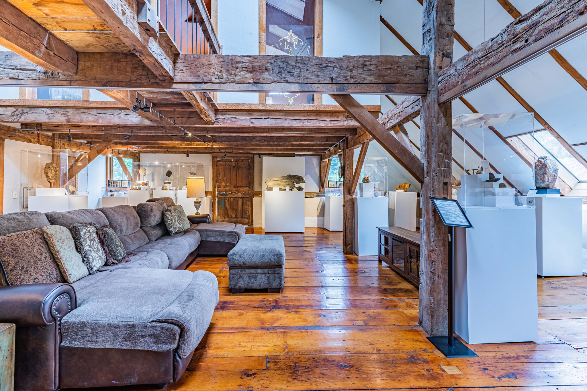 Attic-level open space with original timber frame and museum-style displays