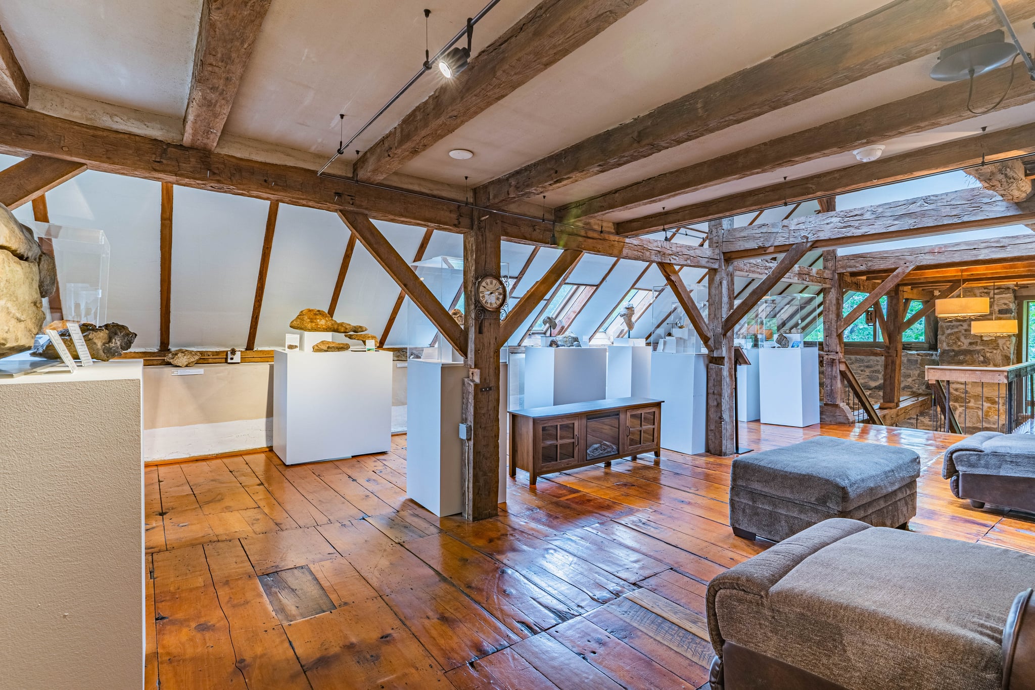 Top-floor loft with exposed post-and-beam structure and wide-plank flooring