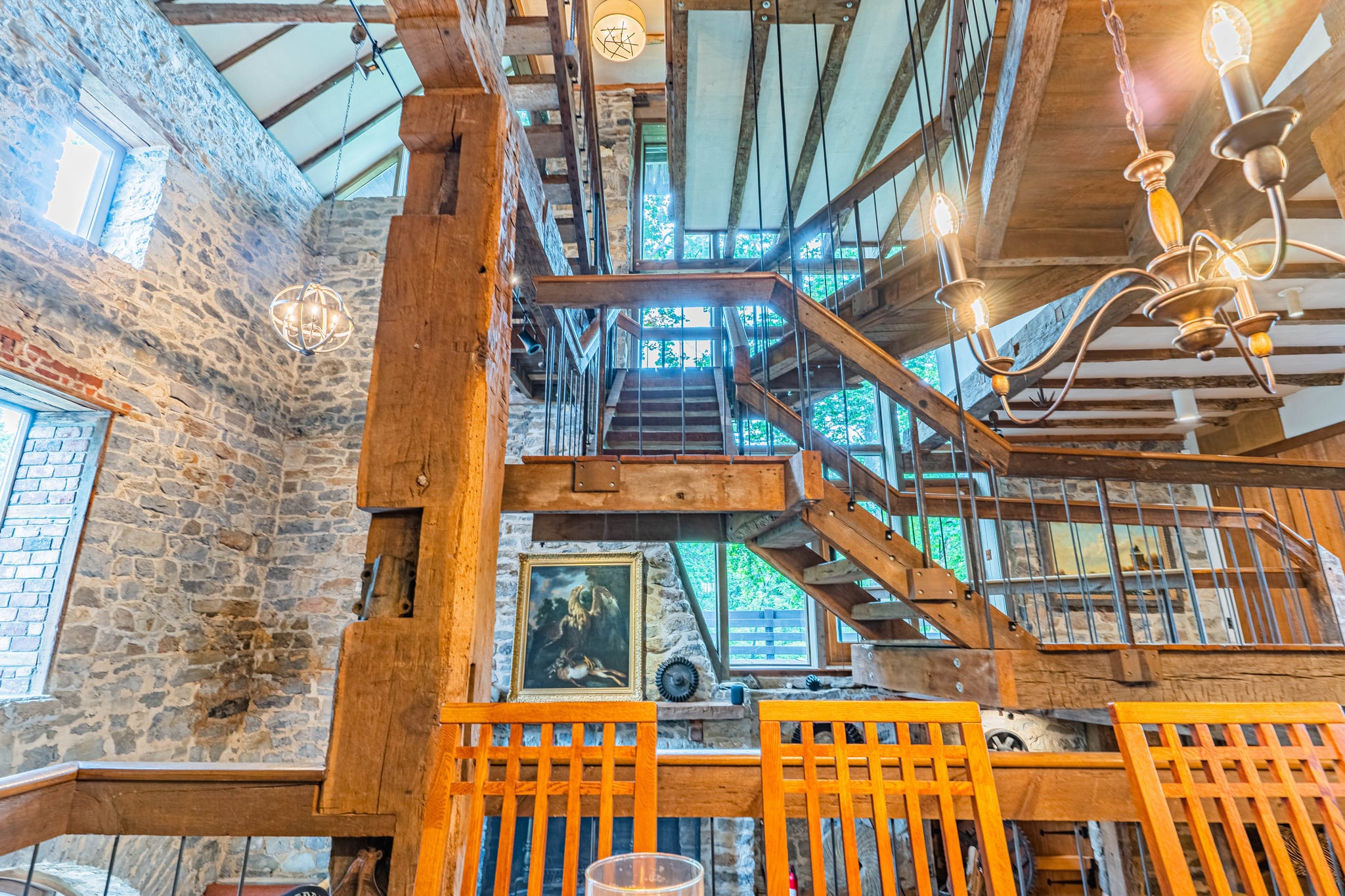 Dramatic multi-level staircase with iron railings and soaring stone walls